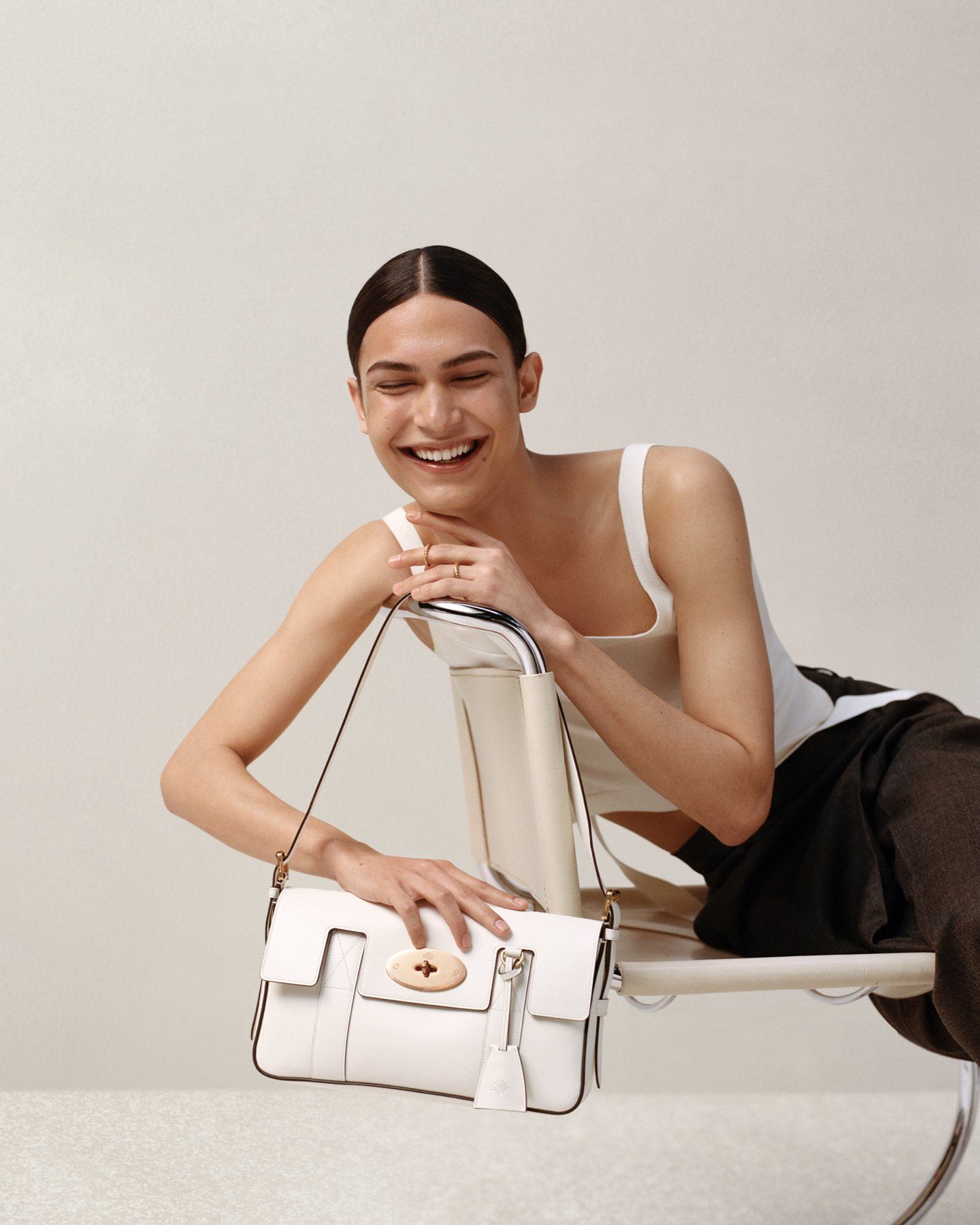model wearing mulberry east west bayswater bag in white